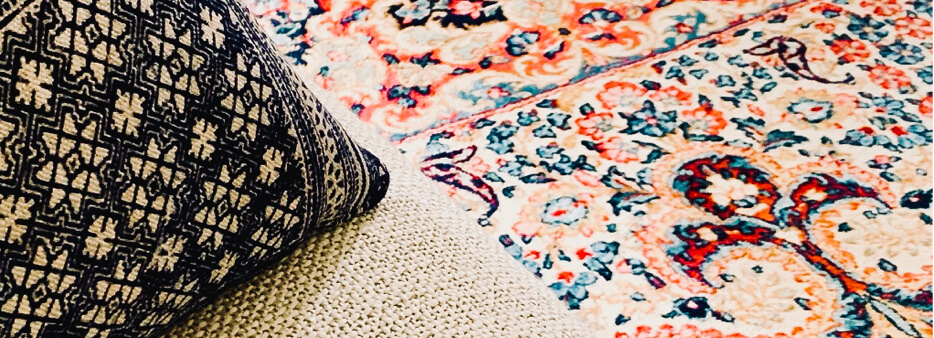 Patterned throw pillow on a floral area rug